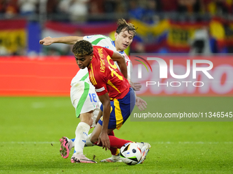 Lamine Yamal right winger of Spain and FC Barcelona and Nicolo Barella central midfield of Italy and Inter Milan compete for the ball during...