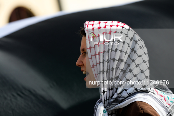 People are participating in a solidarity protest with Palestine in Krakow, Poland, on June 20, 2024, and are marching from the Main Square t...