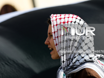 People are participating in a solidarity protest with Palestine in Krakow, Poland, on June 20, 2024, and are marching from the Main Square t...