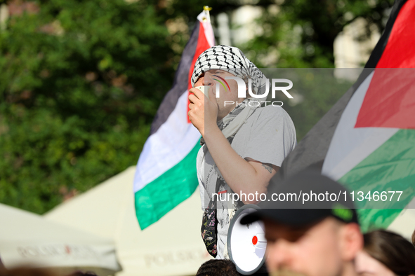 People are participating in a solidarity protest with Palestine in Krakow, Poland, on June 20, 2024, and are marching from the Main Square t...