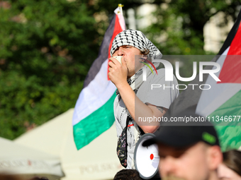 People are participating in a solidarity protest with Palestine in Krakow, Poland, on June 20, 2024, and are marching from the Main Square t...