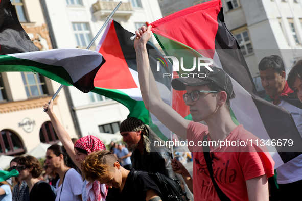 People are participating in a solidarity protest with Palestine in Krakow, Poland, on June 20, 2024, and are marching from the Main Square t...