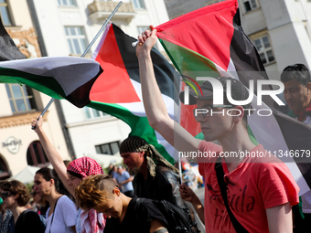 People are participating in a solidarity protest with Palestine in Krakow, Poland, on June 20, 2024, and are marching from the Main Square t...