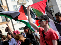 People are participating in a solidarity protest with Palestine in Krakow, Poland, on June 20, 2024, and are marching from the Main Square t...