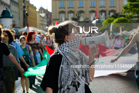 People are participating in a solidarity protest with Palestine in Krakow, Poland, on June 20, 2024, and are marching from the Main Square t...