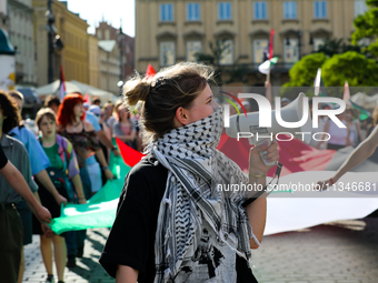 People are participating in a solidarity protest with Palestine in Krakow, Poland, on June 20, 2024, and are marching from the Main Square t...