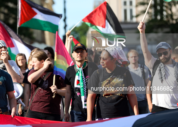 People are participating in a solidarity protest with Palestine in Krakow, Poland, on June 20, 2024, and are marching from the Main Square t...