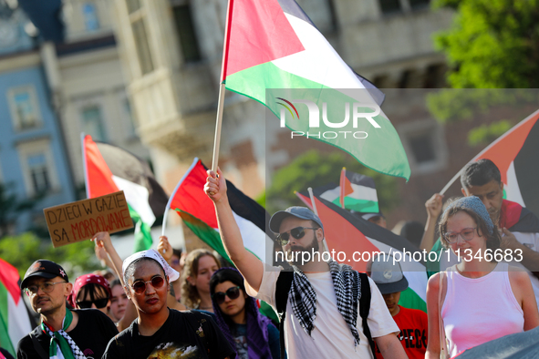 People are participating in a solidarity protest with Palestine in Krakow, Poland, on June 20, 2024, and are marching from the Main Square t...