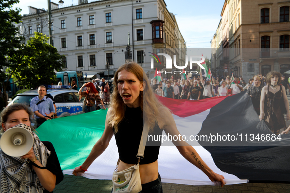 People are participating in a solidarity protest with Palestine in Krakow, Poland, on June 20, 2024, and are marching from the Main Square t...