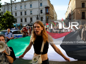 People are participating in a solidarity protest with Palestine in Krakow, Poland, on June 20, 2024, and are marching from the Main Square t...