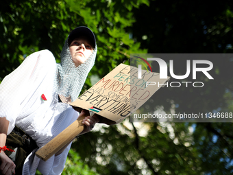 People are participating in a solidarity protest with Palestine in Krakow, Poland, on June 20, 2024, and are marching from the Main Square t...