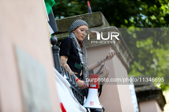 People are participating in a solidarity protest with Palestine in Krakow, Poland, on June 20, 2024, and are marching from the Main Square t...