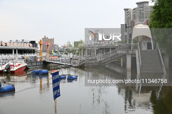 Part of the pedestrian walkway is being submerged by the rising waters of the Sandao pier along the Songhua River in Jilin City, Jilin provi...