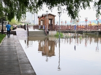 Part of the pedestrian walkway is being submerged by the rising waters of the Sandao pier along the Songhua River in Jilin City, Jilin provi...