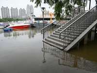 Part of the pedestrian walkway is being submerged by the rising waters of the Sandao pier along the Songhua River in Jilin City, Jilin provi...