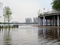 Part of the pedestrian walkway is being submerged by the rising waters of the Sandao pier along the Songhua River in Jilin City, Jilin provi...