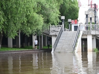 Part of the pedestrian walkway is being submerged by the rising waters of the Sandao pier along the Songhua River in Jilin City, Jilin provi...