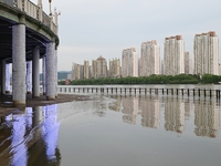 Part of the pedestrian walkway is being submerged by the rising waters of the Sandao pier along the Songhua River in Jilin City, Jilin provi...