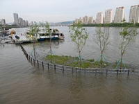 Part of the pedestrian walkway is being submerged by the rising waters of the Sandao pier along the Songhua River in Jilin City, Jilin provi...