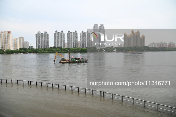 Part of the pedestrian walkway is being submerged by the rising waters of the Sandao pier along the Songhua River in Jilin City, Jilin provi...