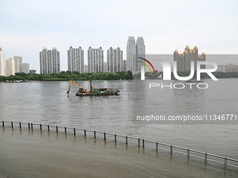 Part of the pedestrian walkway is being submerged by the rising waters of the Sandao pier along the Songhua River in Jilin City, Jilin provi...