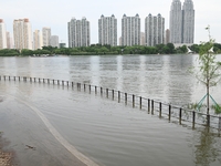 Part of the pedestrian walkway is being submerged by the rising waters of the Sandao pier along the Songhua River in Jilin City, Jilin provi...