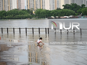 Part of the pedestrian walkway is being submerged by the rising waters of the Sandao pier along the Songhua River in Jilin City, Jilin provi...