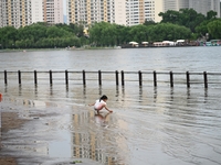 Part of the pedestrian walkway is being submerged by the rising waters of the Sandao pier along the Songhua River in Jilin City, Jilin provi...