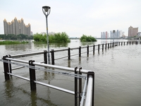 Part of the pedestrian walkway is being submerged by the rising waters of the Sandao pier along the Songhua River in Jilin City, Jilin provi...