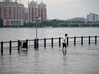 Part of the pedestrian walkway is being submerged by the rising waters of the Sandao pier along the Songhua River in Jilin City, Jilin provi...