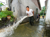 Villagers are cleaning up silt at Changjing Village in Qiukou, Wuyuan county, Shangrao city, East China's Jiangxi province, on June 20, 2024...