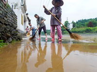 Villagers are cleaning up silt at Changjing Village in Qiukou, Wuyuan county, Shangrao city, East China's Jiangxi province, on June 20, 2024...