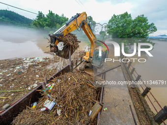 Villagers are cleaning up silt at Changjing Village in Qiukou, Wuyuan county, Shangrao city, East China's Jiangxi province, on June 20, 2024...