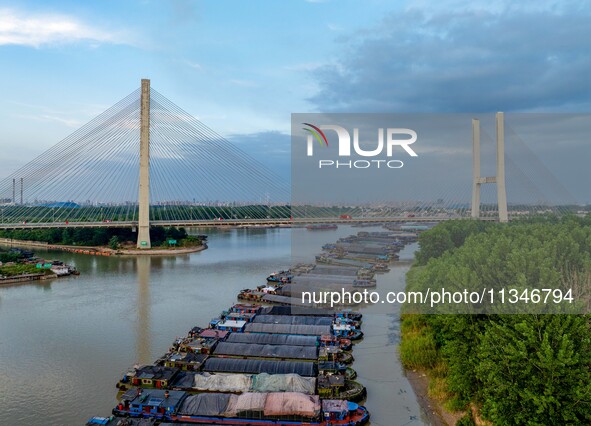 HUAI'AN, CHINA, on June 20, 2024, an aerial photo is showing a large number of ships waiting to be locked upstream of Huaian Lock on the Nor...