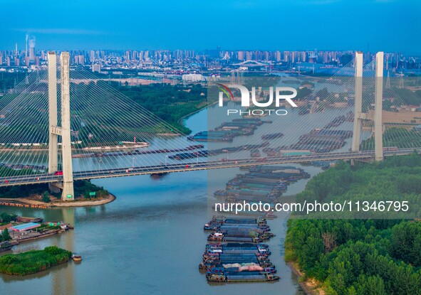 HUAI'AN, CHINA, on June 20, 2024, an aerial photo is showing a large number of ships waiting to be locked upstream of Huaian Lock on the Nor...