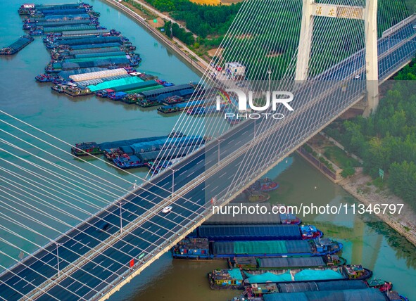 HUAI'AN, CHINA, on June 20, 2024, an aerial photo is showing a large number of ships waiting to be locked upstream of Huaian Lock on the Nor...