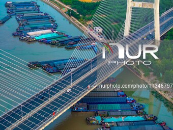 HUAI'AN, CHINA, on June 20, 2024, an aerial photo is showing a large number of ships waiting to be locked upstream of Huaian Lock on the Nor...