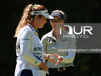 Brooke Henderson of Canada interacts with her caddy on the second green during Day One of the KPMG Women's PGA Championship at Sahalee Count...