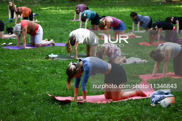 A day ahead of International Yoga Day particpants attend free outdoor yoga classes in Bednarski Park in Krakow, Poland on June 20th. 2024.  