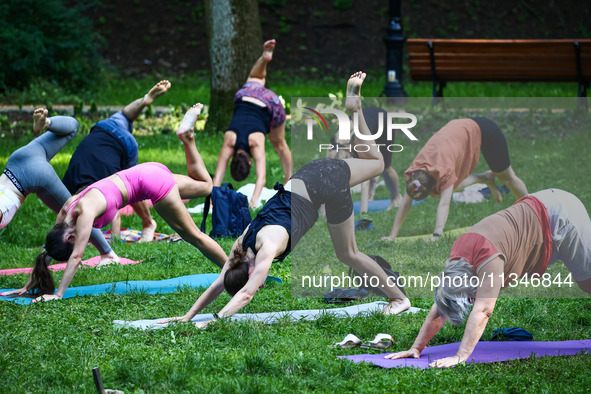 A day ahead of International Yoga Day particpants attend free outdoor yoga classes in Bednarski Park in Krakow, Poland on June 20th. 2024.  