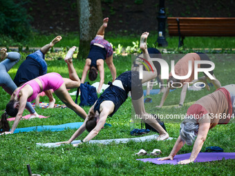 A day ahead of International Yoga Day particpants attend free outdoor yoga classes in Bednarski Park in Krakow, Poland on June 20th. 2024....