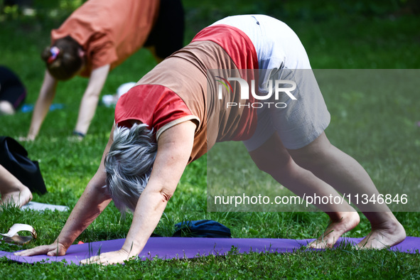 A day ahead of International Yoga Day particpants attend free outdoor yoga classes in Bednarski Park in Krakow, Poland on June 20th. 2024.  