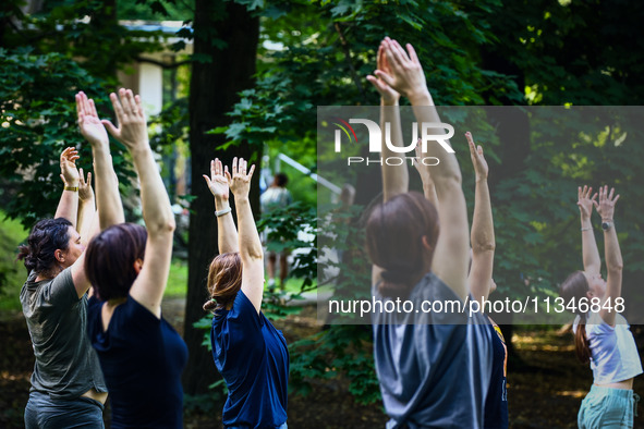 A day ahead of International Yoga Day particpants attend free outdoor yoga classes in Bednarski Park in Krakow, Poland on June 20th. 2024.  