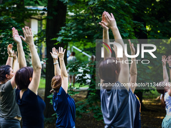 A day ahead of International Yoga Day particpants attend free outdoor yoga classes in Bednarski Park in Krakow, Poland on June 20th. 2024....