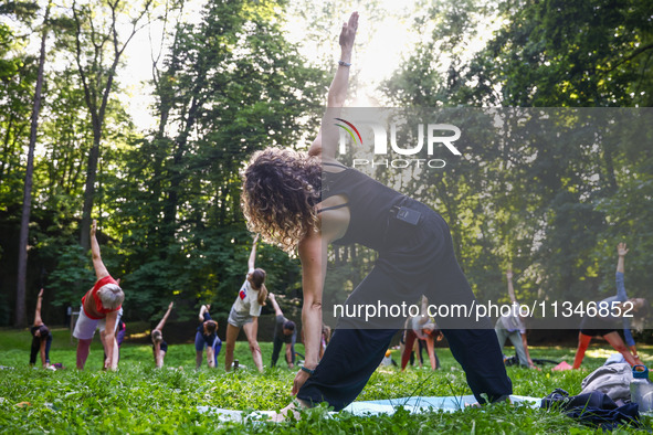 A day ahead of International Yoga Day particpants attend free outdoor yoga classes in Bednarski Park in Krakow, Poland on June 20th. 2024.  