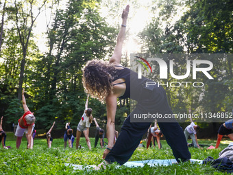 A day ahead of International Yoga Day particpants attend free outdoor yoga classes in Bednarski Park in Krakow, Poland on June 20th. 2024....