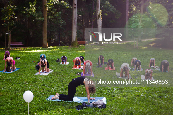 A day ahead of International Yoga Day particpants attend free outdoor yoga classes in Bednarski Park in Krakow, Poland on June 20th. 2024.  