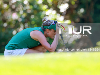 Lexi Thompson of Delray Beach, Florida lines up her putt on the 8th green during the first round of the KPMG Women's PGA Championship at Sah...