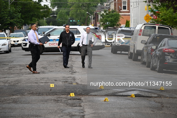 Shell casings are being recovered at the crime scene. A 19-year-old male victim is being shot and killed in Chicago, Illinois, United States...