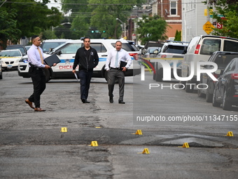 Shell casings are being recovered at the crime scene. A 19-year-old male victim is being shot and killed in Chicago, Illinois, United States...